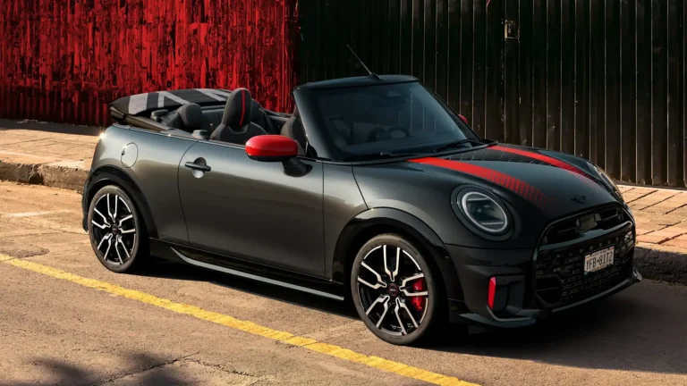 A stylish MINI Cooper convertible in black with red racing stripes, showcased as a marketing asset for MINI dealers.